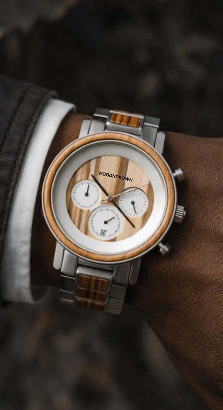 Wooden watch with silver accents on a wrist against a dark background