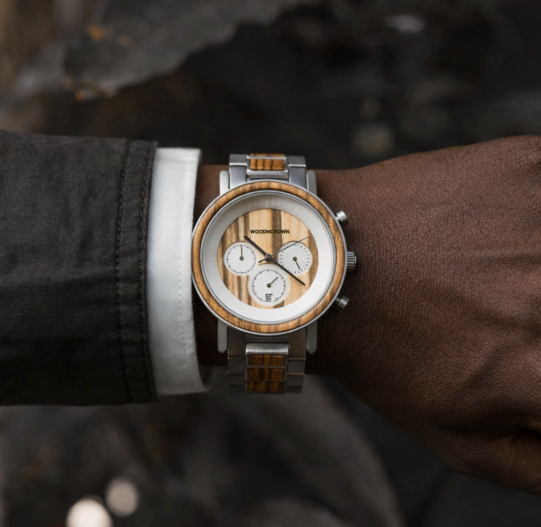 Wooden watch with silver accents on a wrist against a dark background